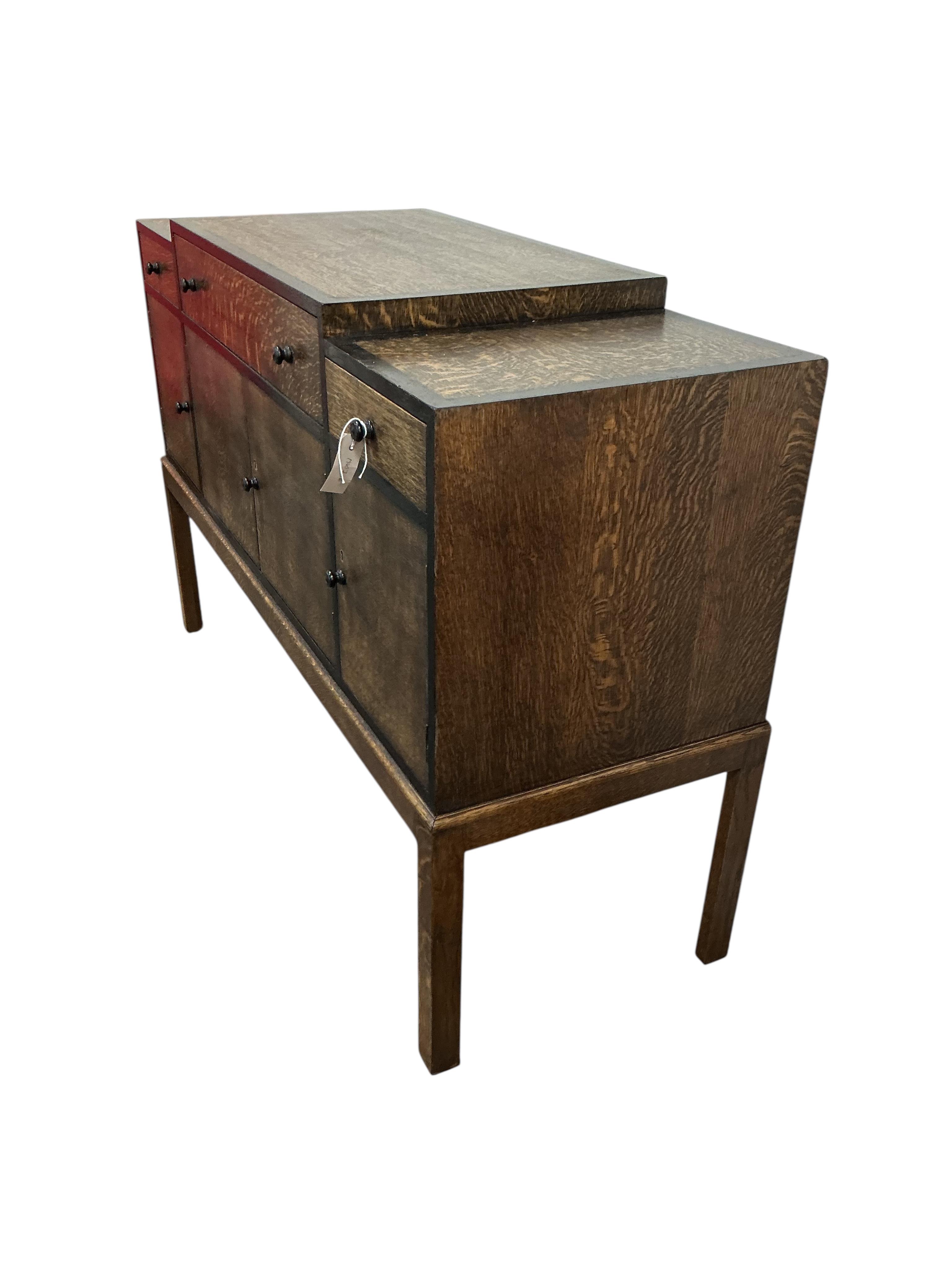 A Heals Art Deco oak and ebony sideboard, width 137cm, depth 49cm, height 92cm.
